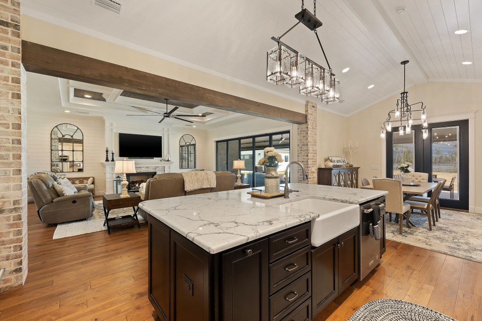 Inspiration for a large country l-shaped eat-in kitchen in Other with a farmhouse sink, shaker cabinets, white cabinets, quartz benchtops, black splashback, marble splashback, stainless steel appliances, medium hardwood floors, with island, beige floor, white benchtop and timber.