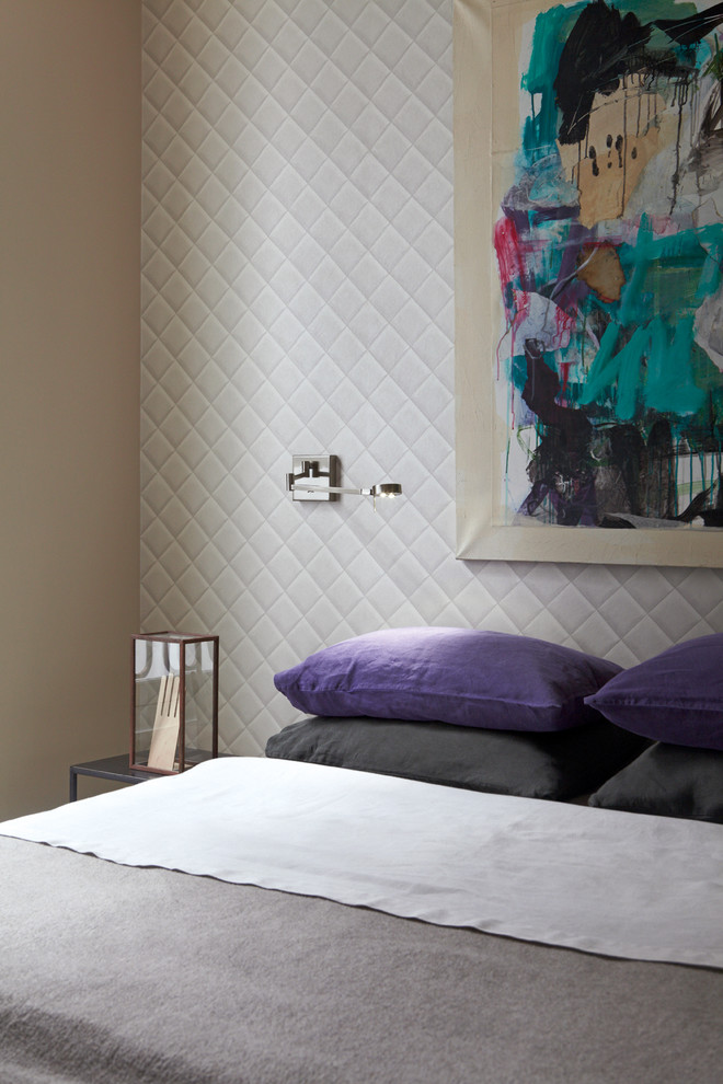 Photo of a contemporary master bedroom in Paris with beige walls, light hardwood floors and wallpaper.