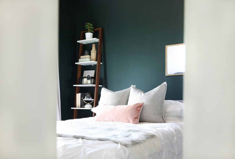 Photo of a small eclectic master bedroom in Toronto with green walls, laminate floors and brown floor.
