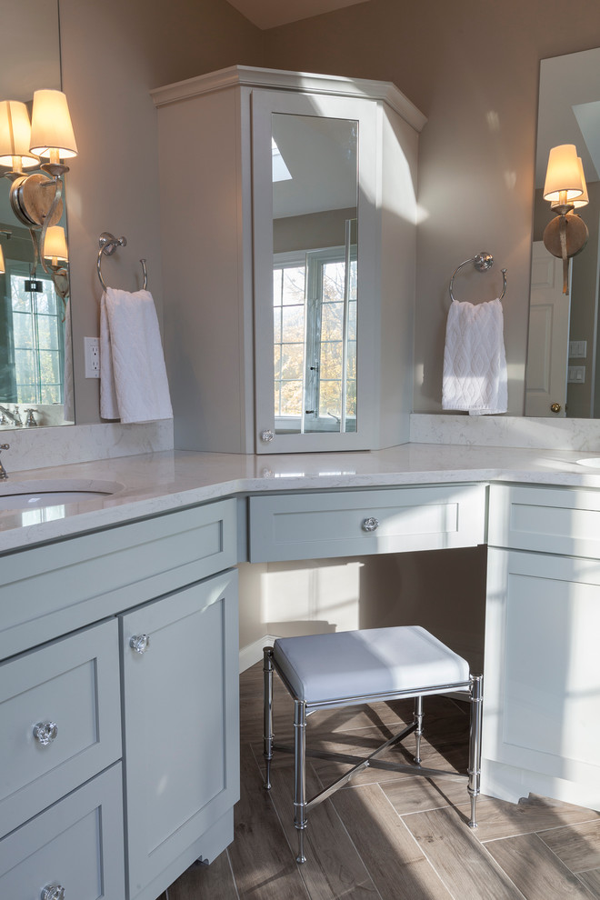 Mid-sized transitional master gray tile and porcelain tile porcelain tile and gray floor freestanding bathtub photo in New York with flat-panel cabinets, gray cabinets, a two-piece toilet, gray walls, an undermount sink, quartz countertops and a hinged shower door