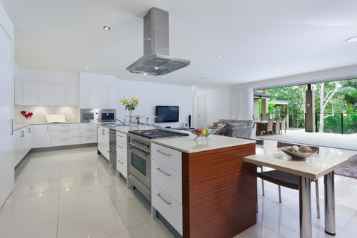 Bright modern kitchen with white cabinets and long island range, showing flush, level cabinet alignment