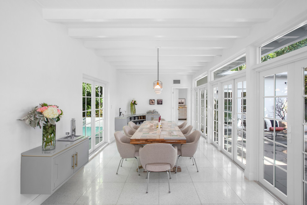 Design ideas for a mid-sized midcentury dining room in Miami with white walls, travertine floors and white floor.