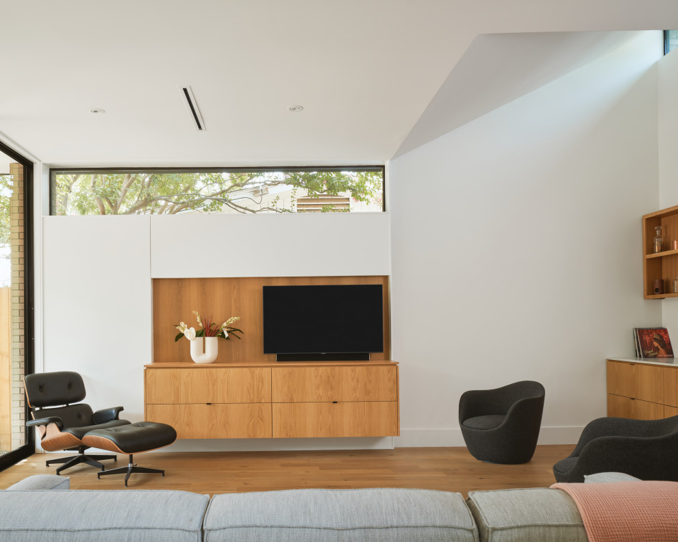Foto di un soggiorno minimalista aperto con TV a parete