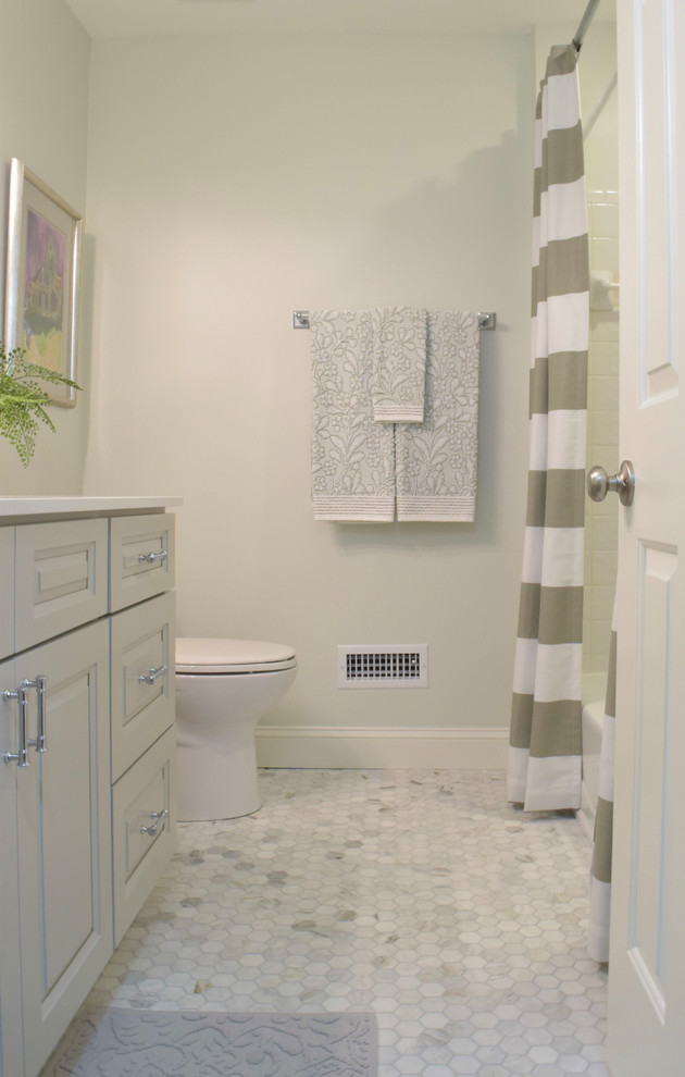 Small transitional bathroom in Atlanta with recessed-panel cabinets, grey cabinets, an alcove tub, a shower/bathtub combo, a two-piece toilet, white tile, ceramic tile, green walls, marble floors, a drop-in sink, engineered quartz benchtops, multi-coloured floor, a shower curtain and white benchtops.