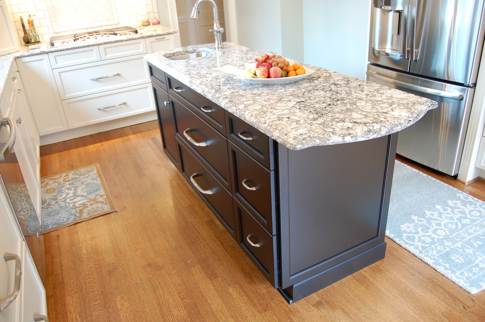 Eat-in kitchen - transitional u-shaped eat-in kitchen idea in Raleigh with an undermount sink, recessed-panel cabinets, white cabinets, quartzite countertops, white backsplash, subway tile backsplash and stainless steel appliances