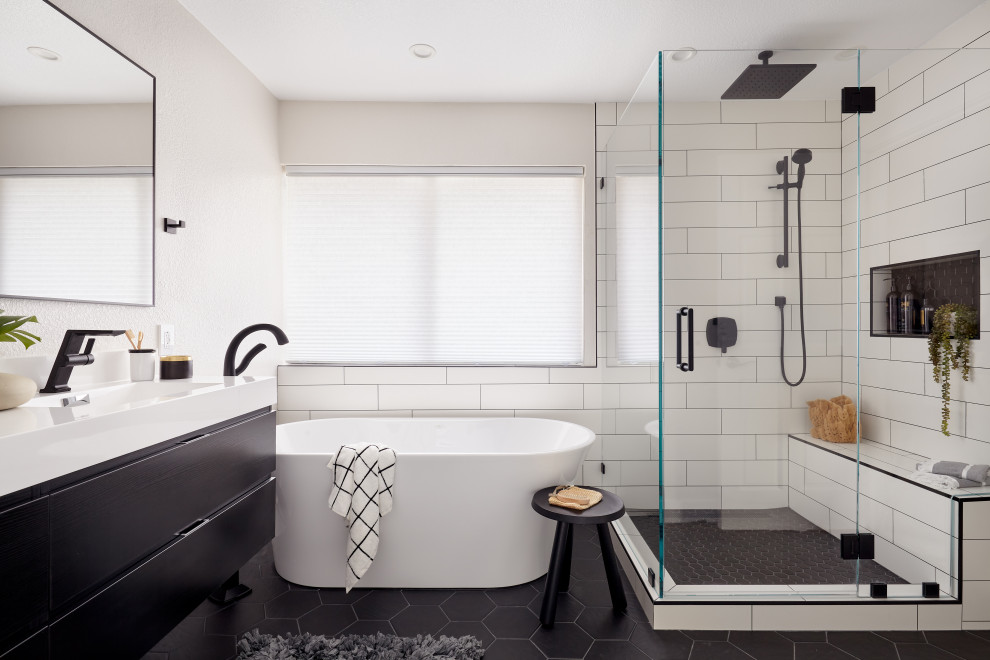 Photo of a large contemporary master bathroom in San Francisco with flat-panel cabinets, black cabinets, a freestanding tub, a corner shower, a one-piece toilet, white tile, porcelain tile, grey walls, porcelain floors, an integrated sink, engineered quartz benchtops, black floor, a hinged shower door, white benchtops, a shower seat, a double vanity and a floating vanity.
