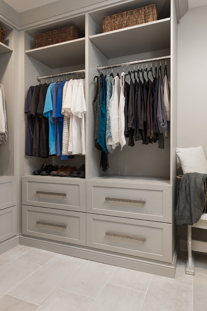 Design ideas for a country gender-neutral walk-in wardrobe in Other with flat-panel cabinets, beige cabinets, porcelain floors and beige floor.