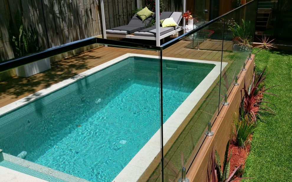 Photo of a mid-sized beach style backyard rectangular aboveground pool with decking.