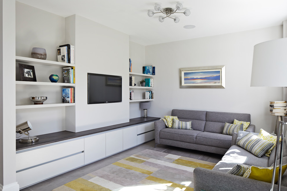 Photo of an expansive contemporary living room in Surrey with porcelain floors, white walls, no fireplace, a wall-mounted tv and grey floor.