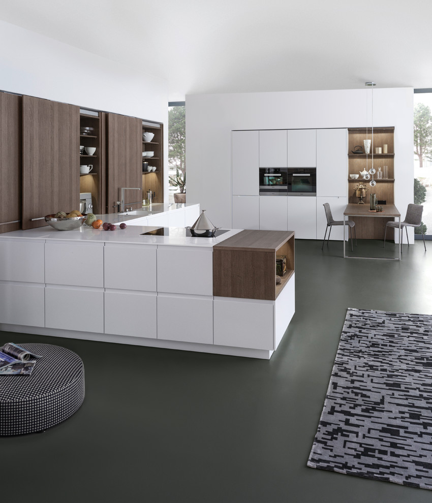 Large modern u-shaped eat-in kitchen in Orange County with an integrated sink, flat-panel cabinets, white cabinets, quartz benchtops, brown splashback, panelled appliances, concrete floors and a peninsula.