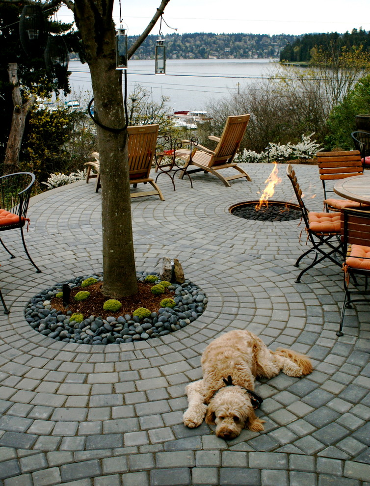 This is an example of a small contemporary patio in Seattle with concrete pavers and a fire feature.