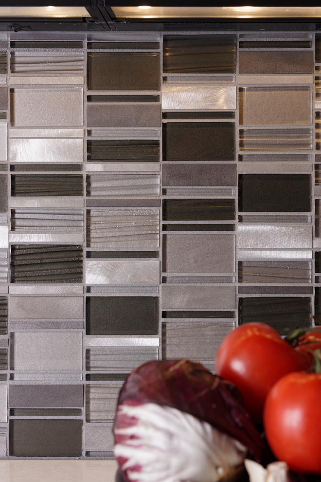 Inspiration for a mid-sized transitional l-shaped ceramic tile enclosed kitchen remodel in Baltimore with a single-bowl sink, flat-panel cabinets, dark wood cabinets, quartz countertops, metallic backsplash, mosaic tile backsplash, stainless steel appliances and an island