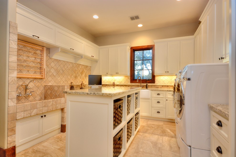 Country u-shaped utility room in Austin with a farmhouse sink, flat-panel cabinets, white cabinets, granite benchtops and a side-by-side washer and dryer.