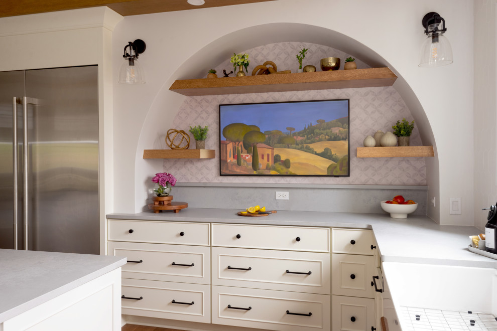 Eat-in kitchen - large medium tone wood floor and exposed beam eat-in kitchen idea with white backsplash, stainless steel appliances and an island