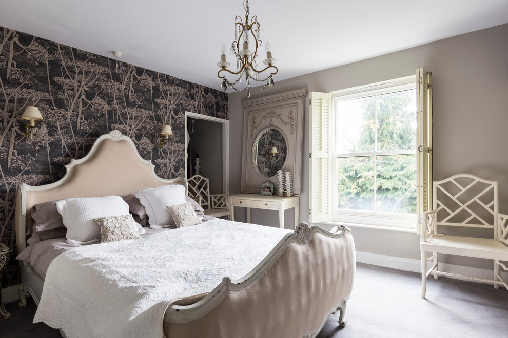 Design ideas for a traditional master bedroom in London with grey walls.