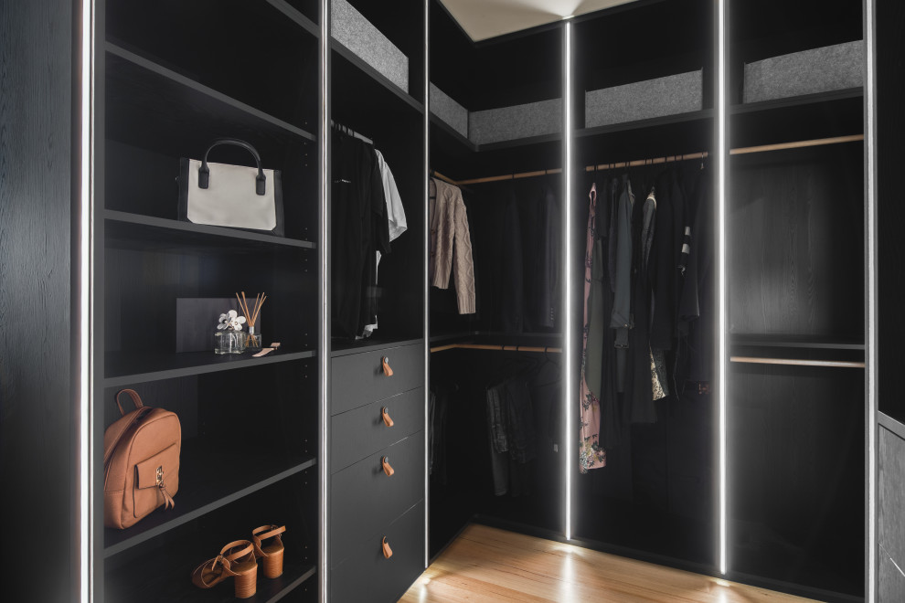 Design ideas for a medium sized contemporary gender neutral walk-in wardrobe in Melbourne with beaded cabinets, black cabinets, medium hardwood flooring and a coffered ceiling.