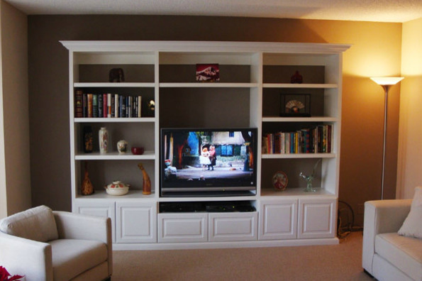 Mid-sized traditional open concept living room in Other with beige walls, carpet, no fireplace and a built-in media wall.