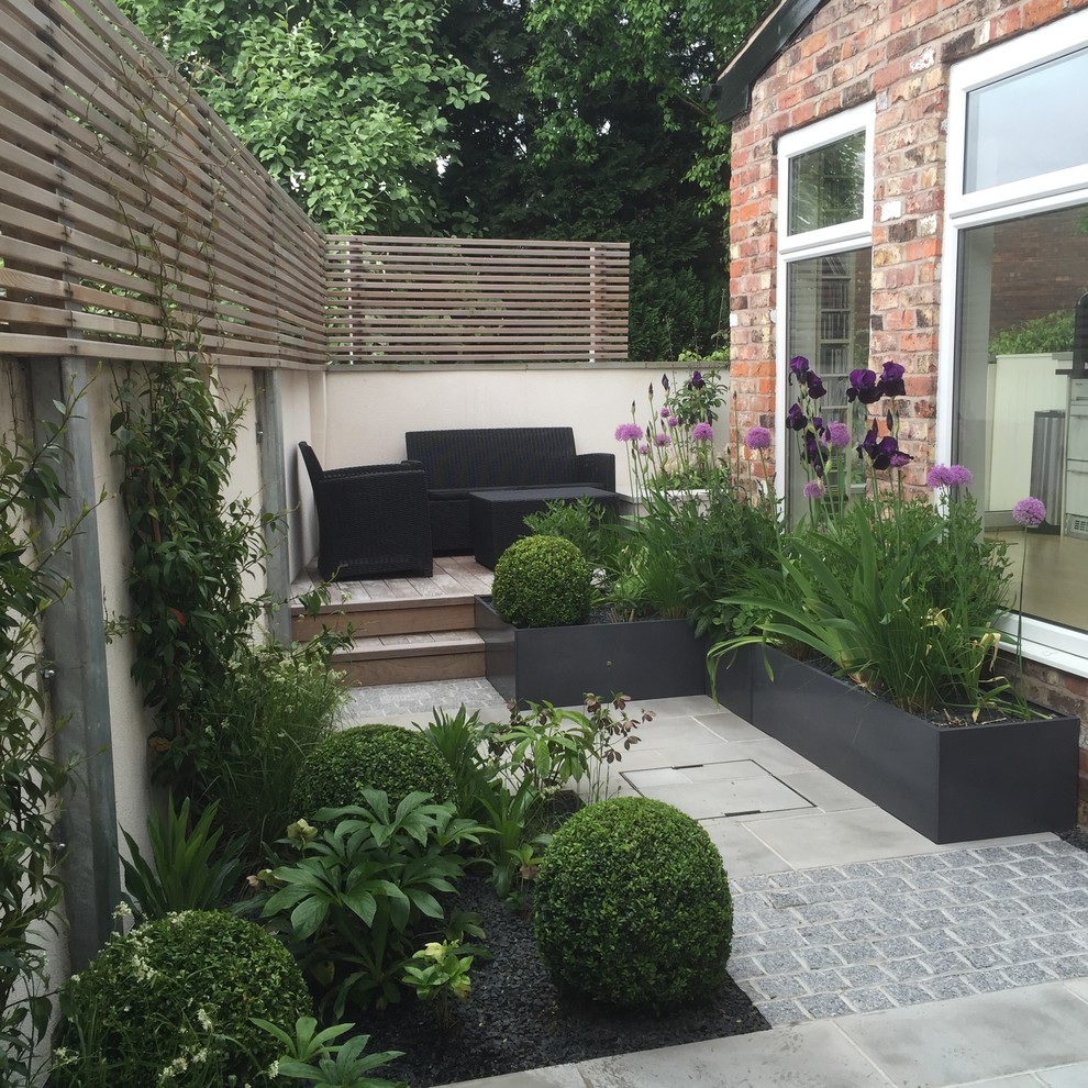 Photo of a small contemporary courtyard formal garden in Manchester with a container garden and natural stone pavers.