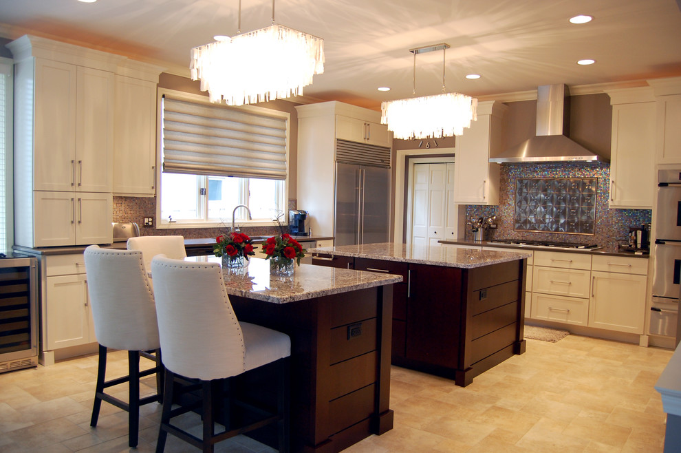 Example of a large transitional l-shaped eat-in kitchen design in Chicago with shaker cabinets, white cabinets, glass tile backsplash, gray walls, an undermount sink, granite countertops, metallic backsplash, stainless steel appliances and two islands