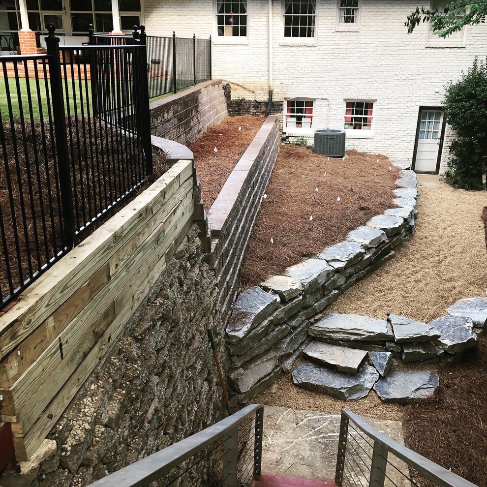 Photo of a traditional backyard garden in Birmingham with a retaining wall.