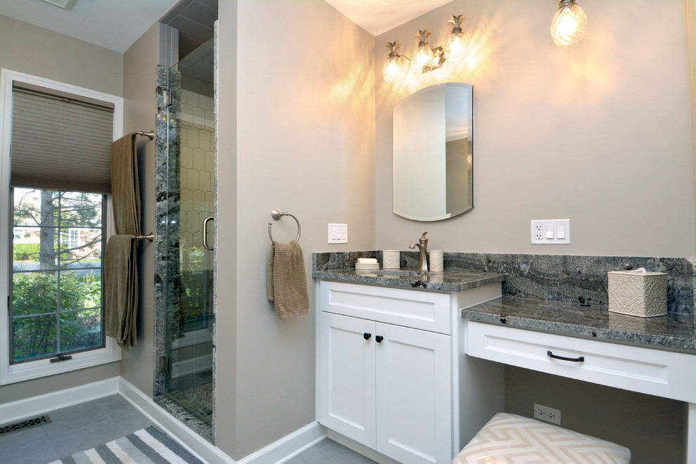 Example of a large transitional master gray tile and porcelain tile porcelain tile and gray floor bathroom design in Chicago with shaker cabinets, white cabinets, a two-piece toilet, gray walls, an undermount sink, granite countertops and a hinged shower door