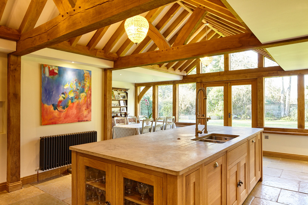 This is an example of an expansive traditional kitchen/diner in Berkshire with a built-in sink, glass-front cabinets, limestone worktops, grey splashback, mirror splashback, integrated appliances, limestone flooring and an island.