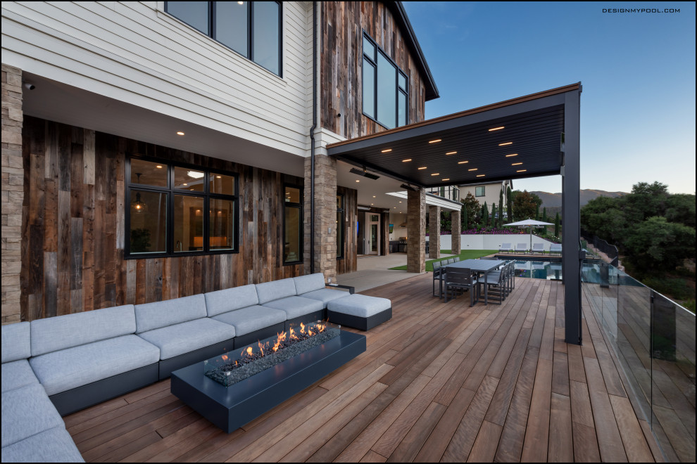 Design ideas for a mid-sized modern backyard patio in Los Angeles with a fire feature, decking and a pergola.