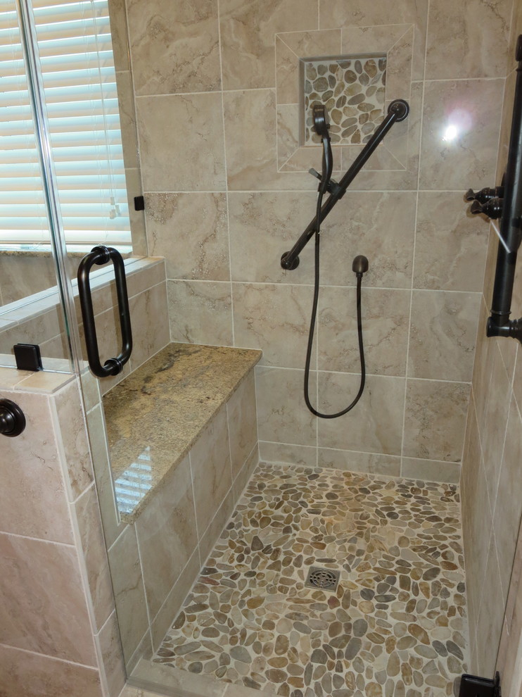 Photo of a mid-sized traditional master bathroom in Austin with an undermount sink, raised-panel cabinets, grey cabinets, granite benchtops, a corner shower, gray tile, porcelain tile, beige walls and pebble tile floors.