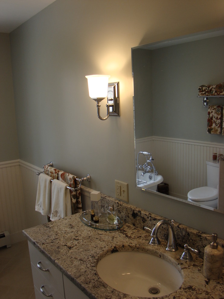 Inspiration for a mid-sized traditional master bathroom in Portland Maine with an undermount sink, recessed-panel cabinets, white cabinets, granite benchtops, a freestanding tub, an alcove shower, a two-piece toilet, beige tile, ceramic tile, green walls and ceramic floors.