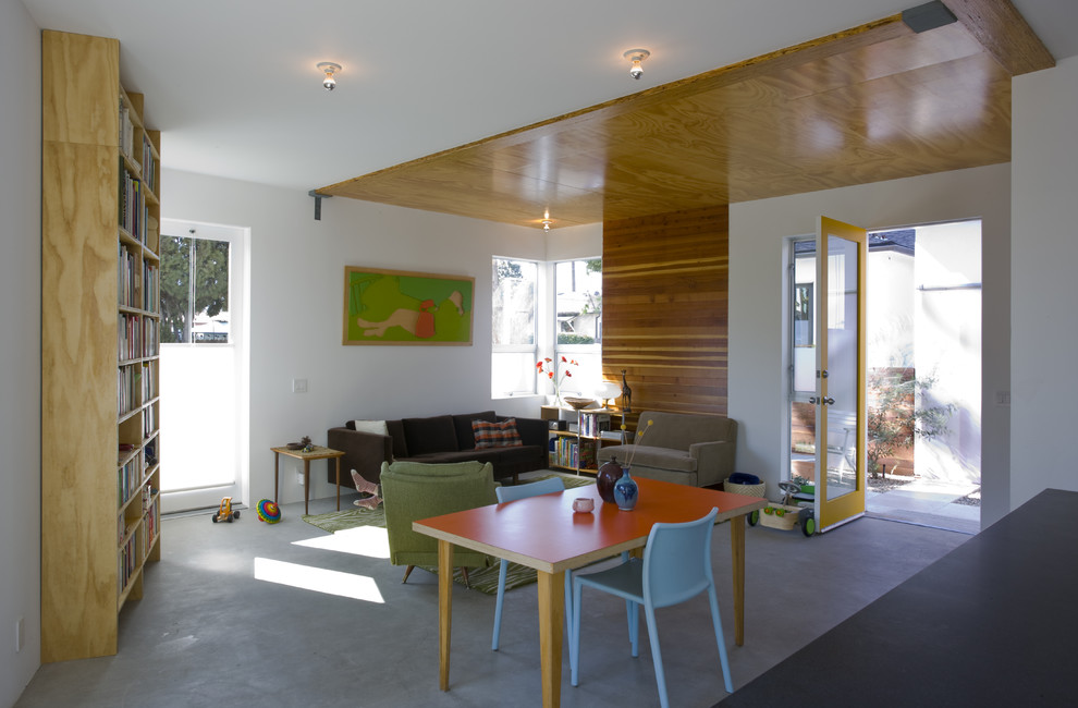 Inspiration for a modern living room in Los Angeles with white walls and concrete floors.