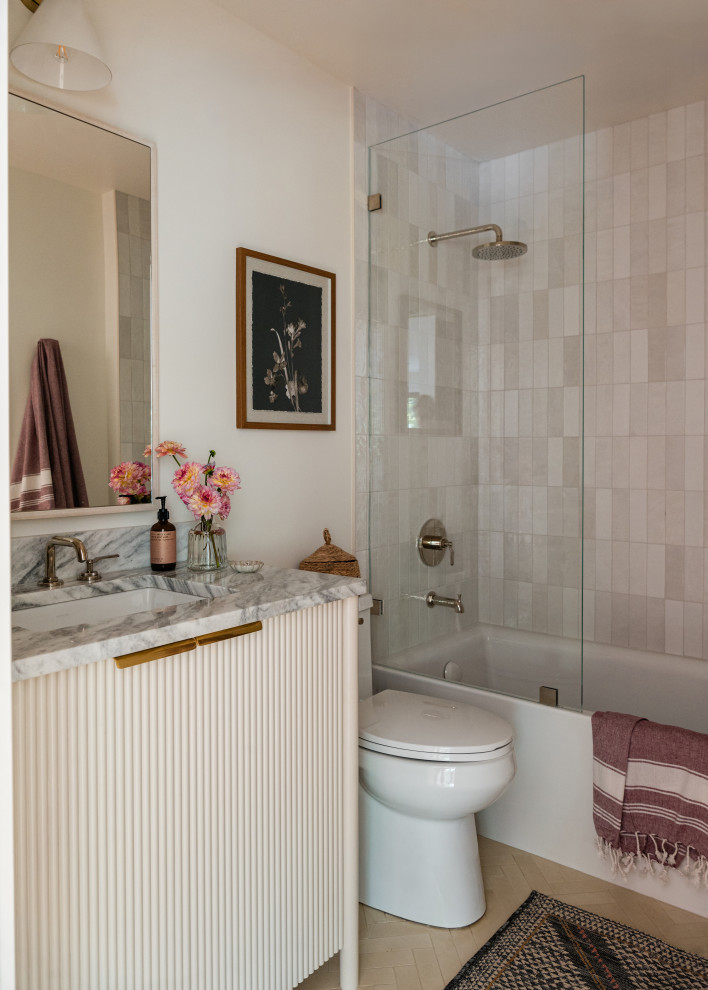 Alcove bathtub - mid-sized transitional kids' white tile and porcelain tile cement tile floor, beige floor and single-sink alcove bathtub idea in Chicago with furniture-like cabinets, beige cabinets, a one-piece toilet, white walls, an undermount sink, quartz countertops, a hinged shower door, gray countertops and a freestanding vanity