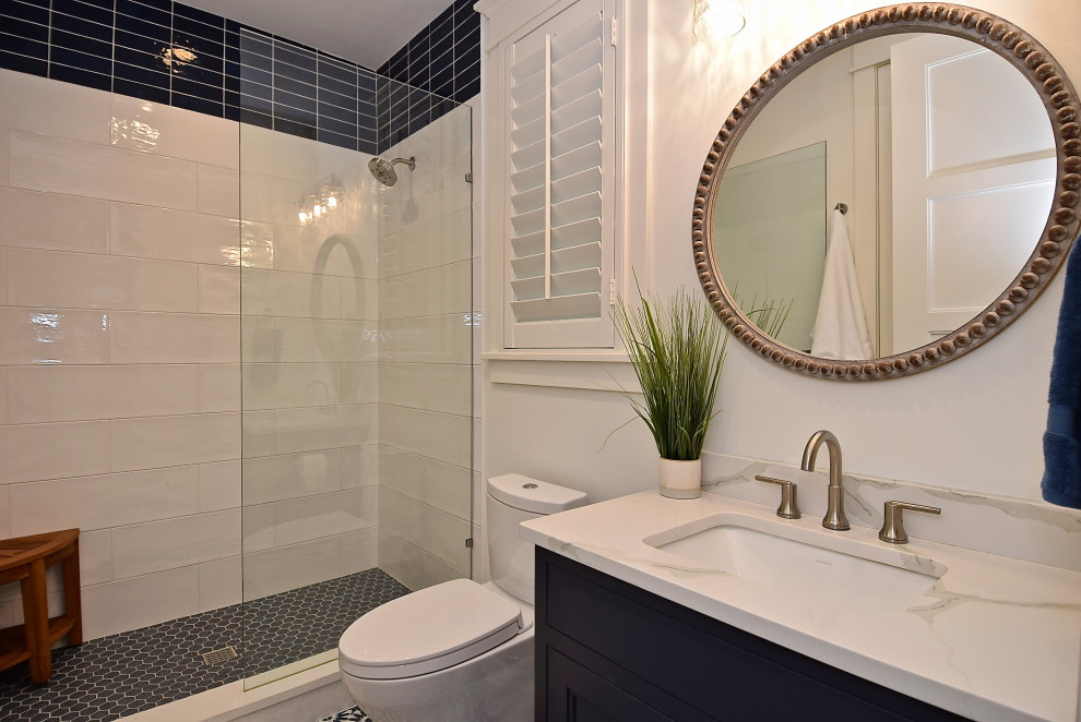 Design ideas for a mid-sized beach style bathroom in Tampa with an alcove shower, white tile, white walls, an undermount sink, engineered quartz benchtops, blue floor, a hinged shower door, white benchtops, blue cabinets, ceramic tile, cement tiles, beaded inset cabinets and a two-piece toilet.