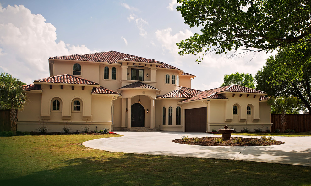 Photo of an expansive mediterranean two-storey stucco beige house exterior in Dallas with a shingle roof and a hip roof.