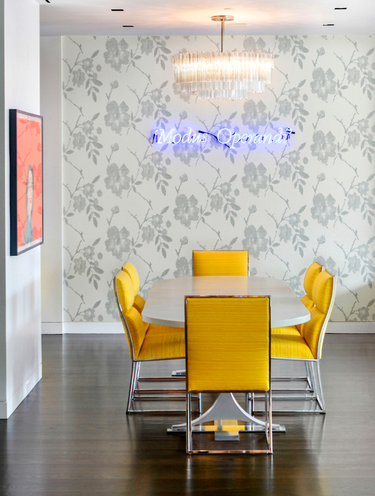 This is an example of a contemporary dining room in New York with multi-coloured walls and dark hardwood floors.