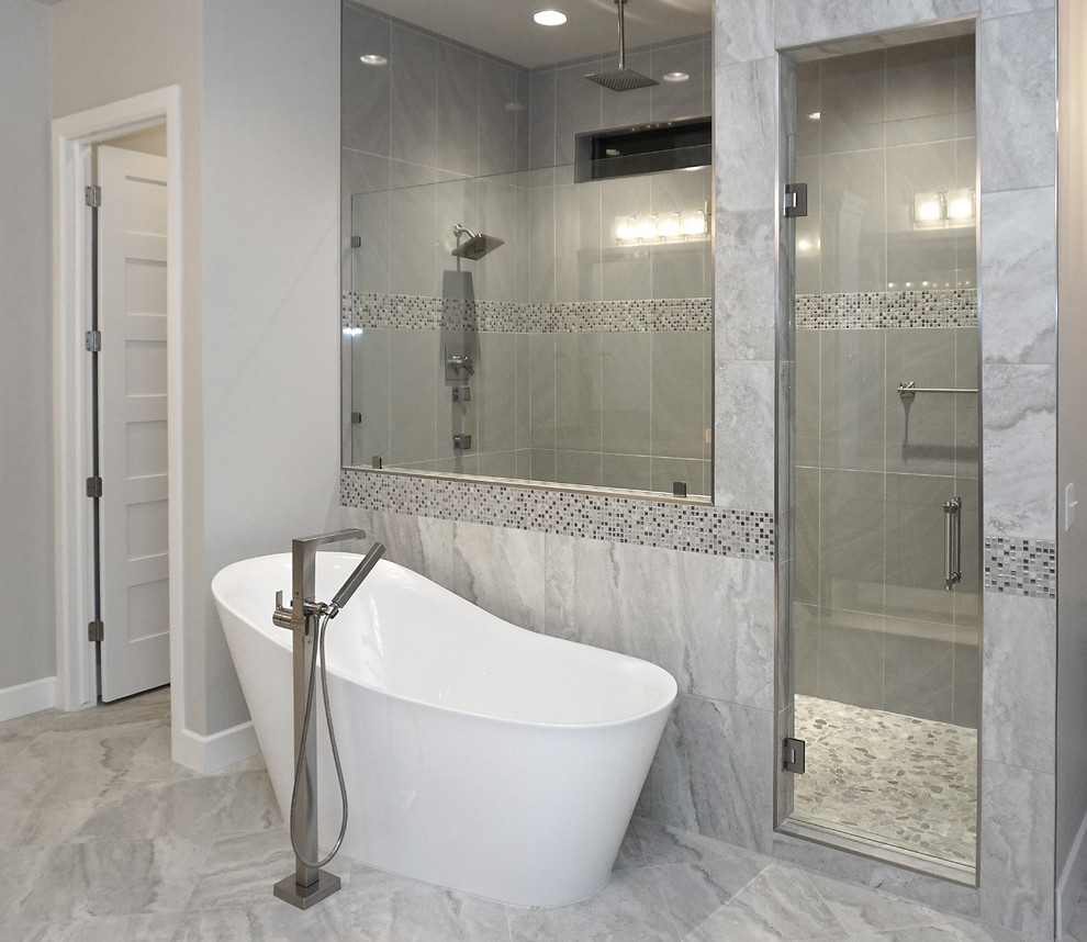 This is an example of a large contemporary master wet room bathroom in Oklahoma City with shaker cabinets, grey cabinets, a freestanding tub, gray tile, porcelain tile, grey walls, porcelain floors, an undermount sink, engineered quartz benchtops, grey floor and a hinged shower door.