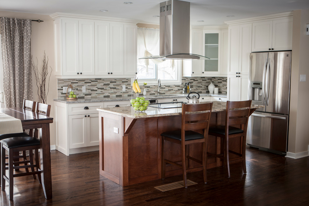 Mid-sized transitional l-shaped dark wood floor eat-in kitchen photo with a double-bowl sink, shaker cabinets, medium tone wood cabinets, granite countertops, beige backsplash, glass tile backsplash, stainless steel appliances and an island