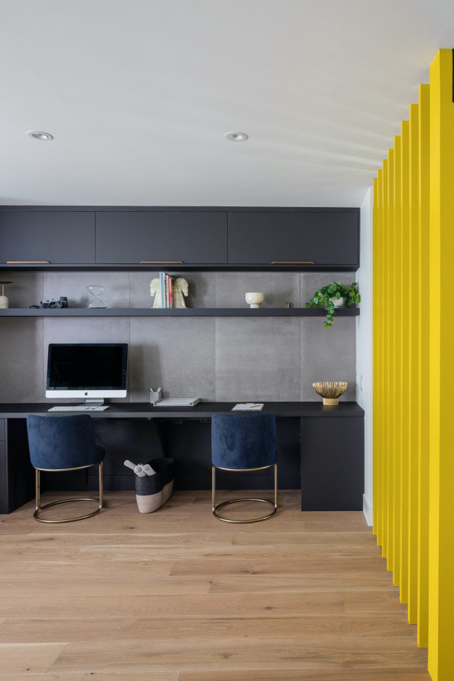 Photo of a contemporary home office in Vancouver with grey walls and a built-in desk.
