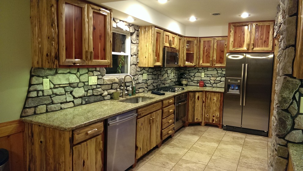 Inspiration for a small rustic u-shaped ceramic tile eat-in kitchen remodel with a double-bowl sink, shaker cabinets, distressed cabinets, granite countertops, gray backsplash, stone slab backsplash, stainless steel appliances and an island