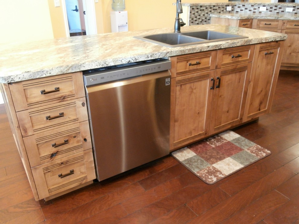 Inspiration for a large rustic single-wall dark wood floor and brown floor eat-in kitchen remodel with shaker cabinets, medium tone wood cabinets, laminate countertops, metallic backsplash, stainless steel appliances and two islands