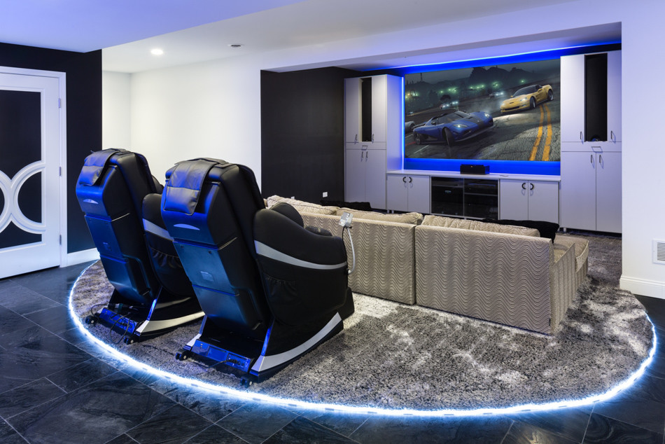 This is an example of a large contemporary home theatre in Chicago with ceramic floors and a built-in media wall.