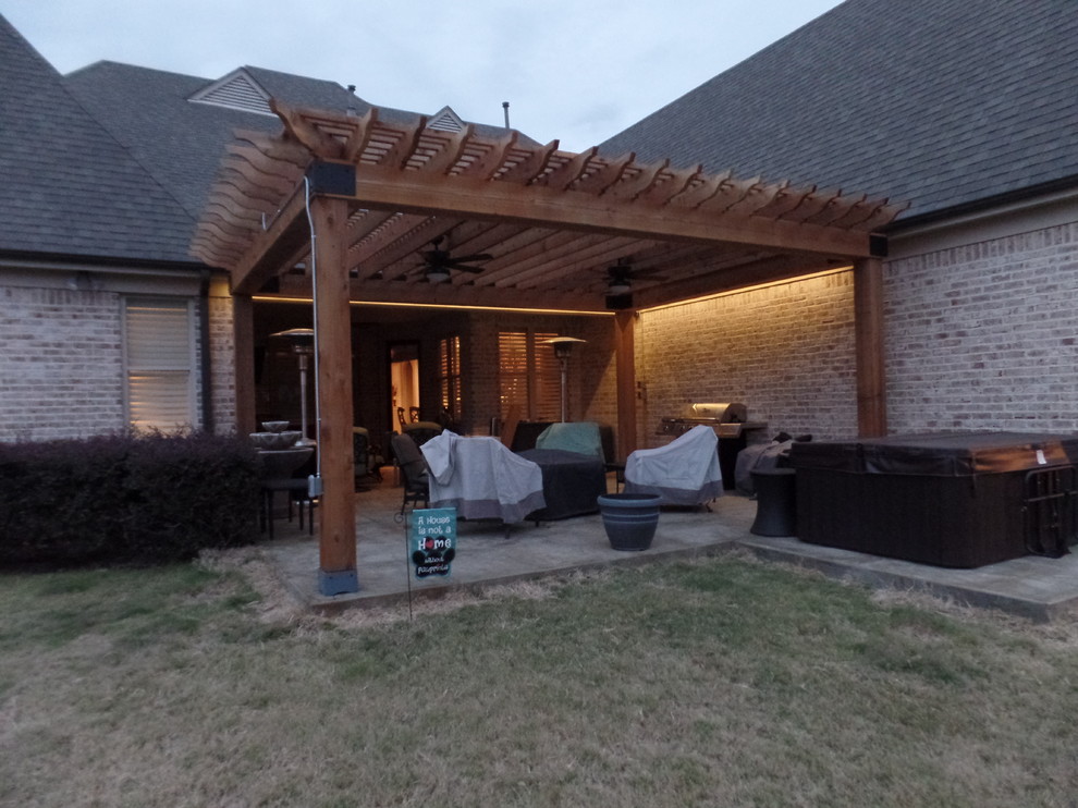 Design ideas for a large country backyard patio in Other with stamped concrete and a pergola.