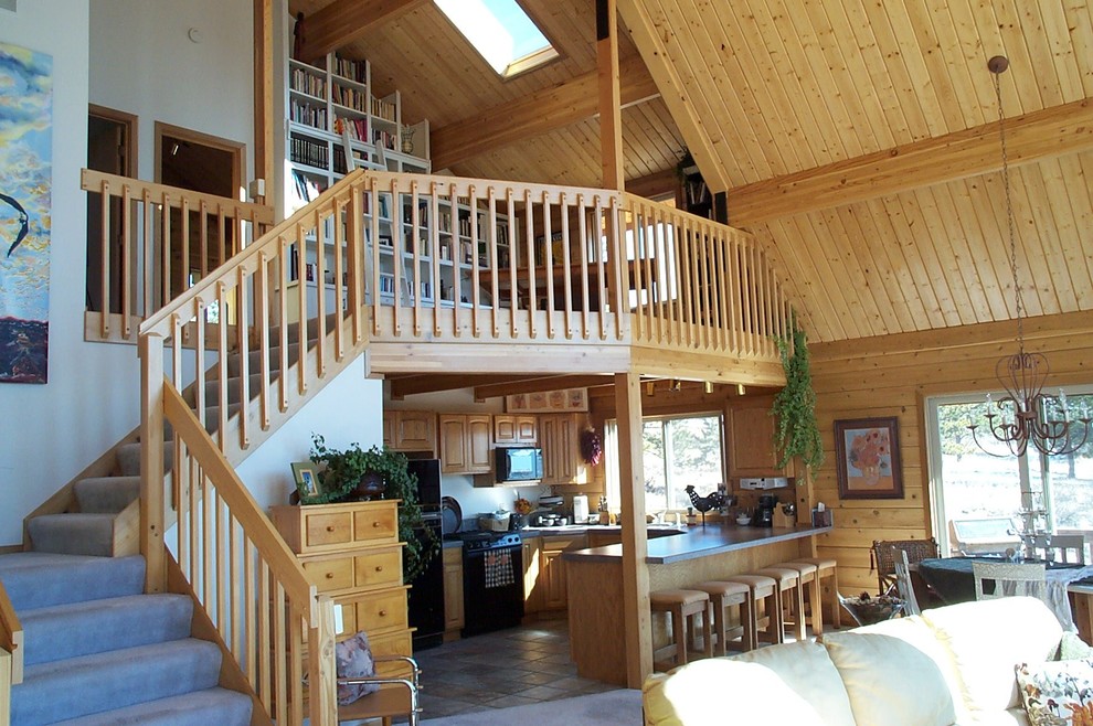 Family room library - large rustic loft-style carpeted and beige floor family room library idea in Denver with brown walls, no fireplace and no tv