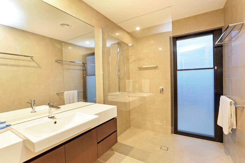 Design ideas for a mid-sized contemporary kids bathroom in Melbourne with furniture-like cabinets, medium wood cabinets, multi-coloured tile, stone tile and engineered quartz benchtops.