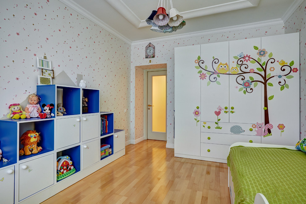 This is an example of a mid-sized scandinavian gender-neutral kids' room in Saint Petersburg with multi-coloured walls and medium hardwood floors.