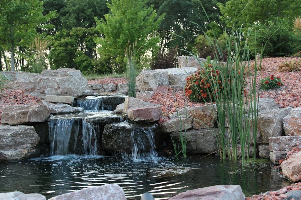 Inspiration for a traditional full sun backyard stone formal garden.
