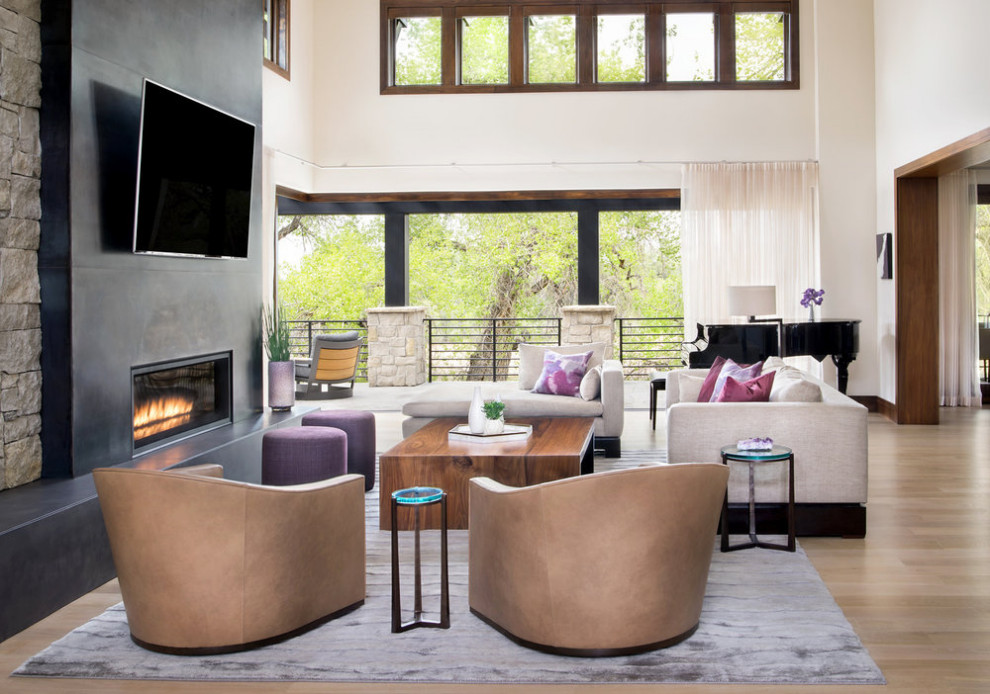 This is an example of a medium sized contemporary formal enclosed living room in Denver with carpet, a standard fireplace, a metal fireplace surround and a wall mounted tv.