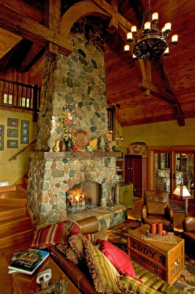 This is an example of a country living room in Minneapolis with a stone fireplace surround.