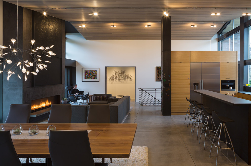 Design ideas for a large midcentury open plan dining in Seattle with white walls, concrete floors, a ribbon fireplace and a plaster fireplace surround.