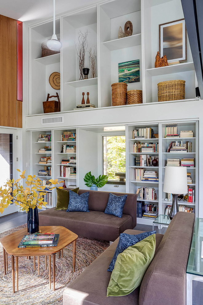 This is an example of a mid-sized contemporary open concept living room in Boston with a library, white walls, porcelain floors, no tv, grey floor and vaulted.