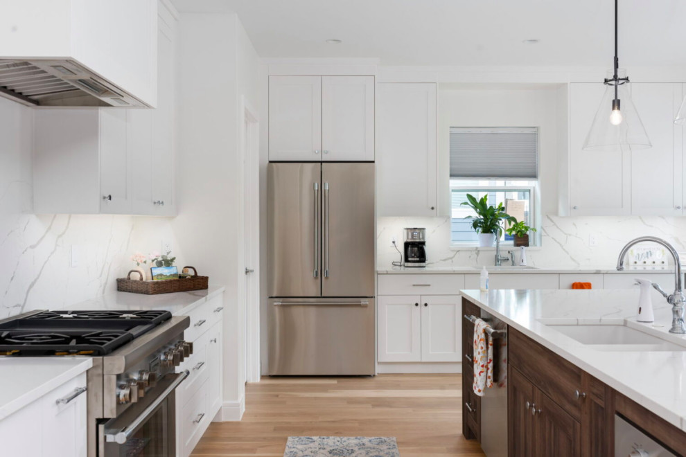Large transitional l-shaped medium tone wood floor, brown floor and coffered ceiling open concept kitchen photo in Austin with an undermount sink, beaded inset cabinets, white cabinets, quartz countertops, white backsplash, quartz backsplash, stainless steel appliances, an island and white countertops